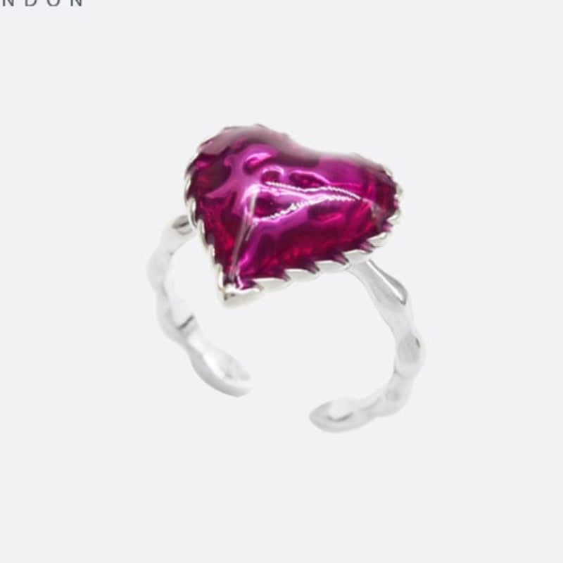 Silver ring with a pink heart-shaped gemstone on a white background, branded 'SAHI LONDON'.