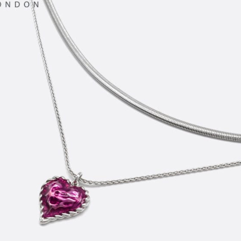 Silver necklace with a pink heart-shaped pendant on a white background, featuring the brand 'SAHI LONDON'.